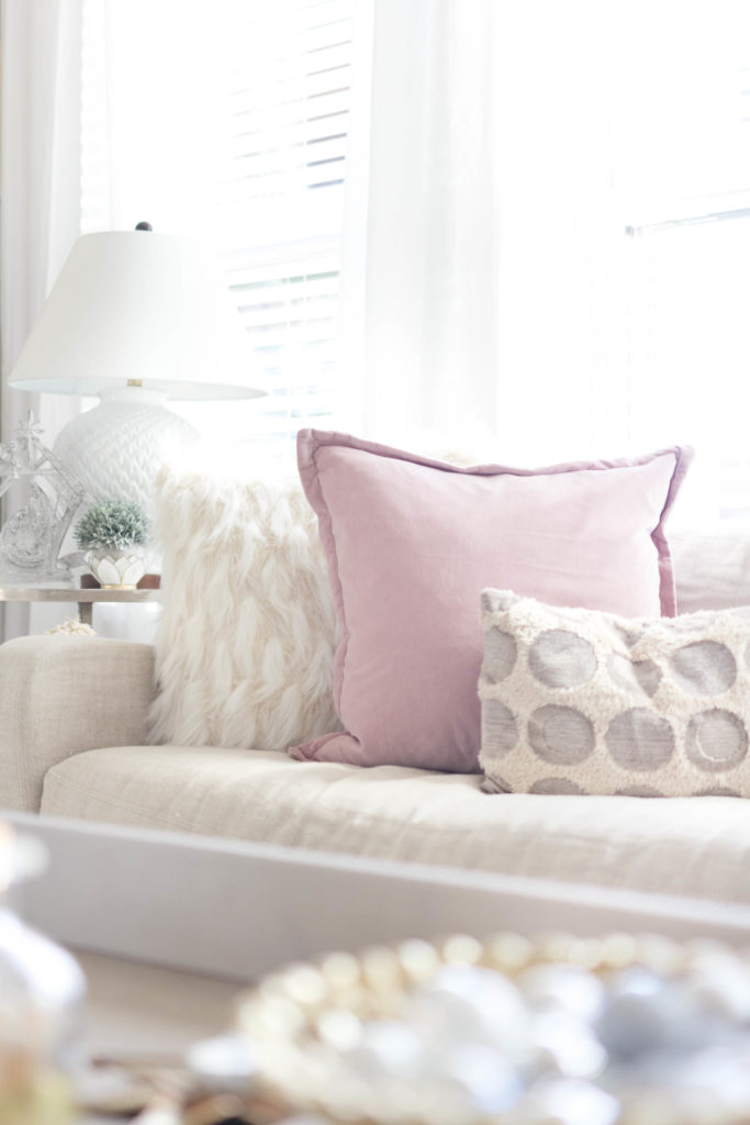 cozy mix of throw pillows-bohemain-glam-christmas-home-tour-iris-nacole-living-room-tour