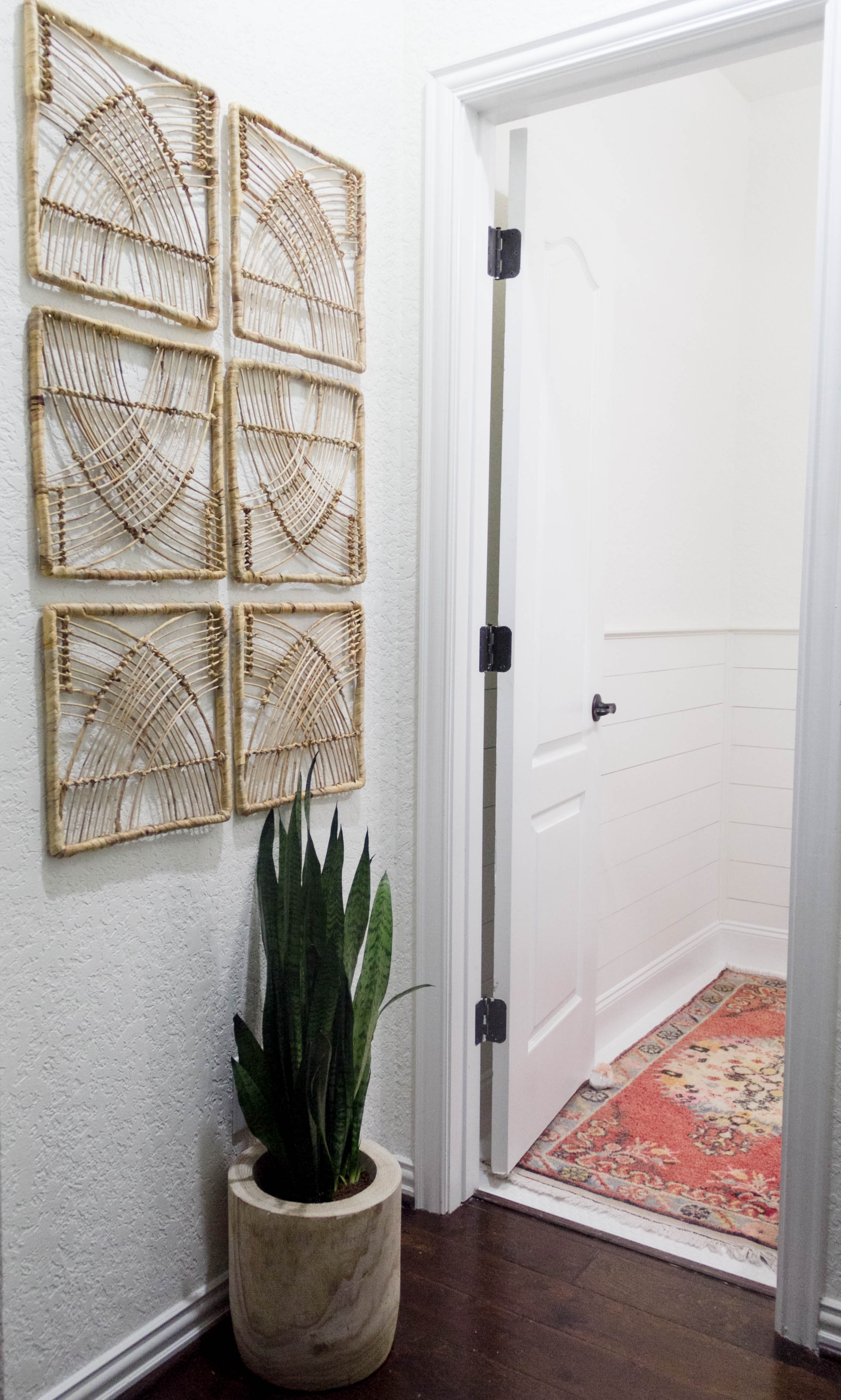 Art wall in a bright and welcoming mudroom/powder room combo with a modern-casual-beach feel. Designed by: IrisNacole.com