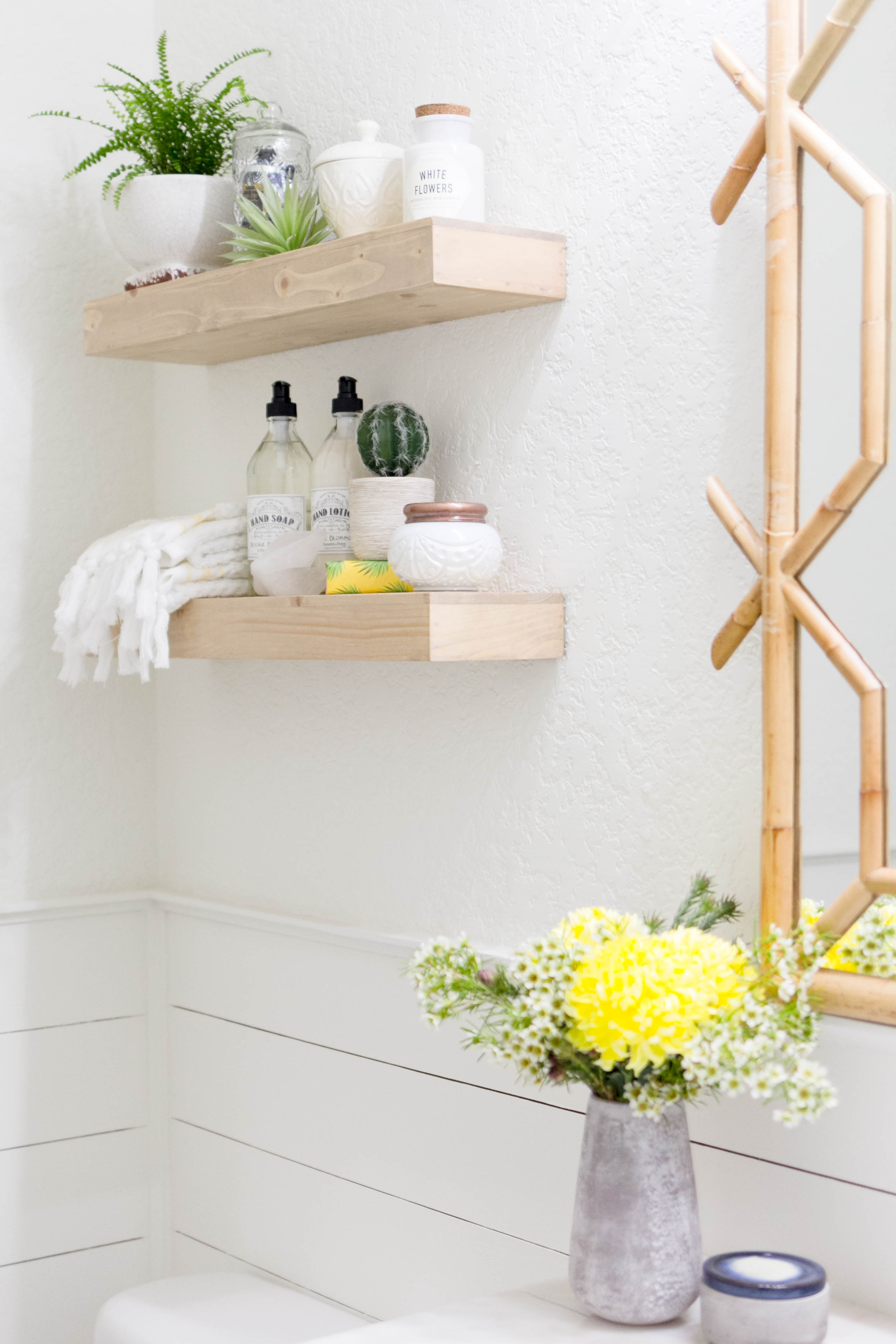 Floating Shelves & Serena & Lily bamboo mirror in a bright and welcoming mudroom/powder room combo with a modern-casual-beach feel. Designed by: IrisNacole.com