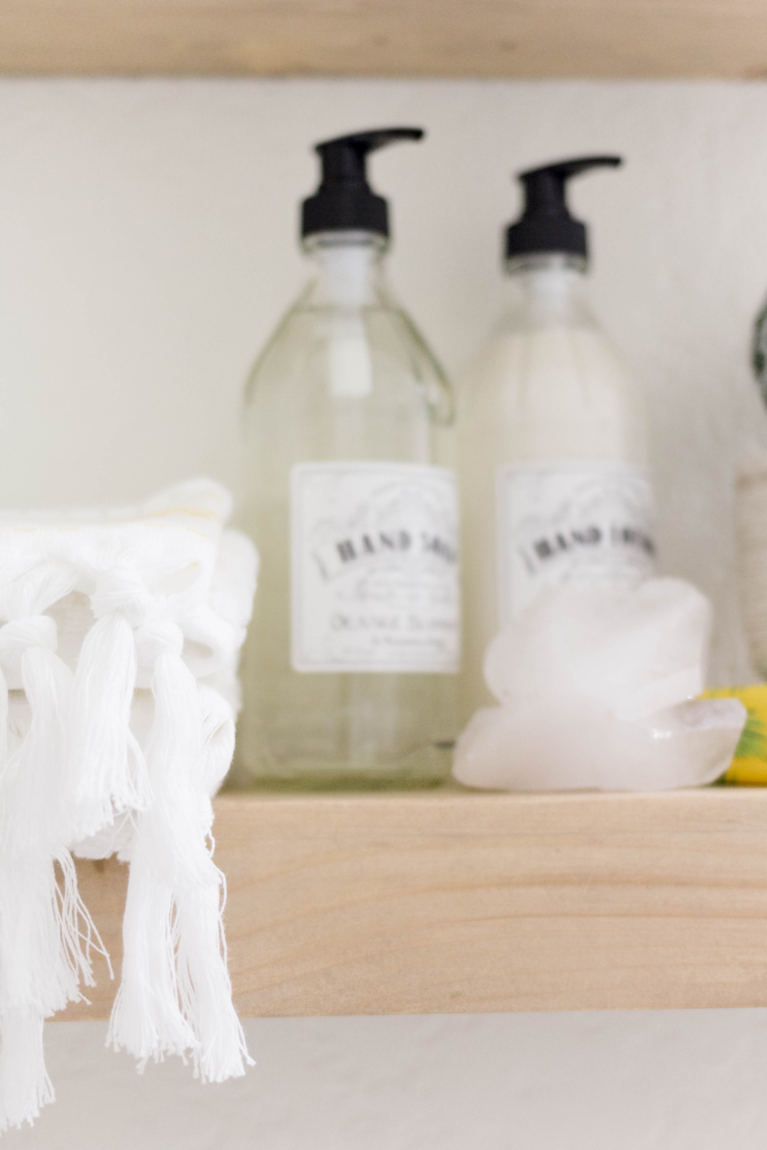 Floating Shelf Styling in a bright and welcoming mudroom/powder room combo with a modern-casual-beach feel. Designed by: IrisNacole.com