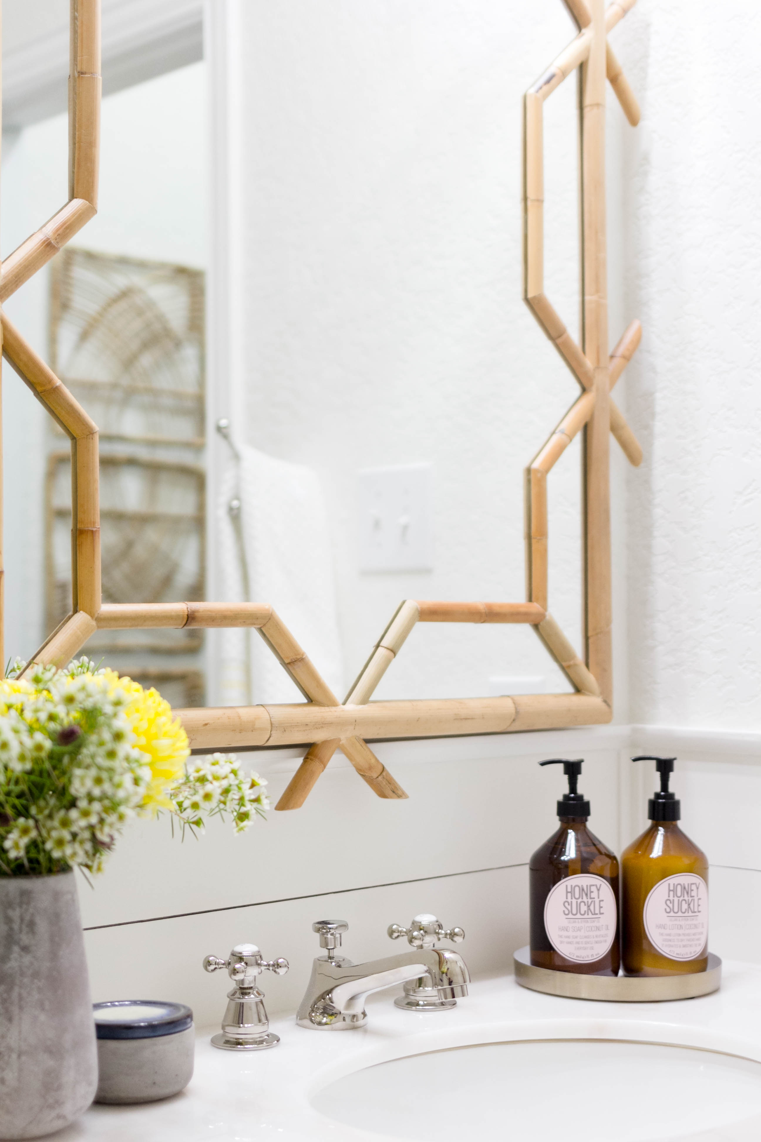 Serena & Lily bamboo mirror in a bright and welcoming mudroom/powder room combo with a modern-casual-beach feel. Designed by: IrisNacole.com