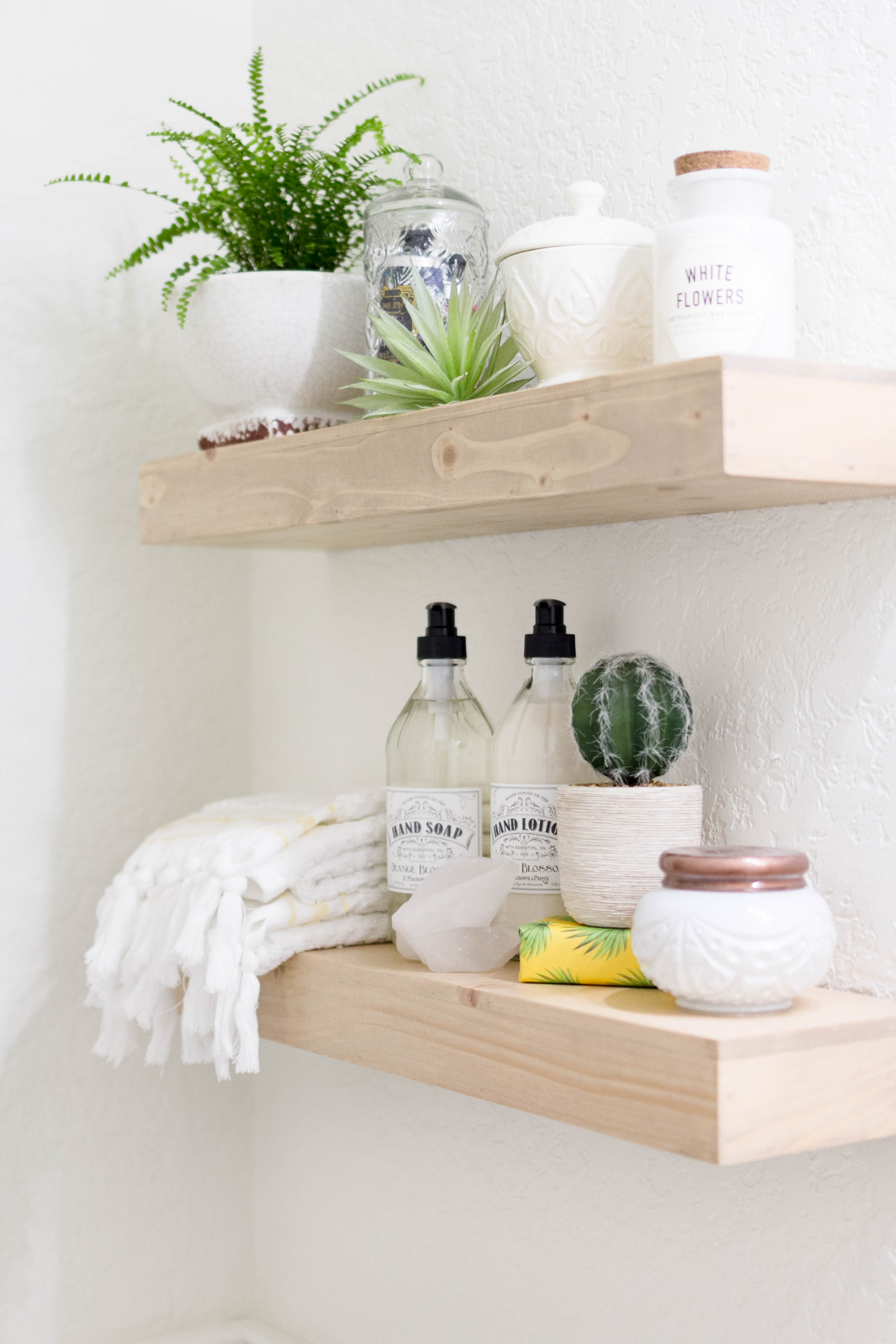 Floating Shelf Styling in a bright and welcoming mudroom/powder room combo with a modern-casual-beach feel. Designed by: IrisNacole.com