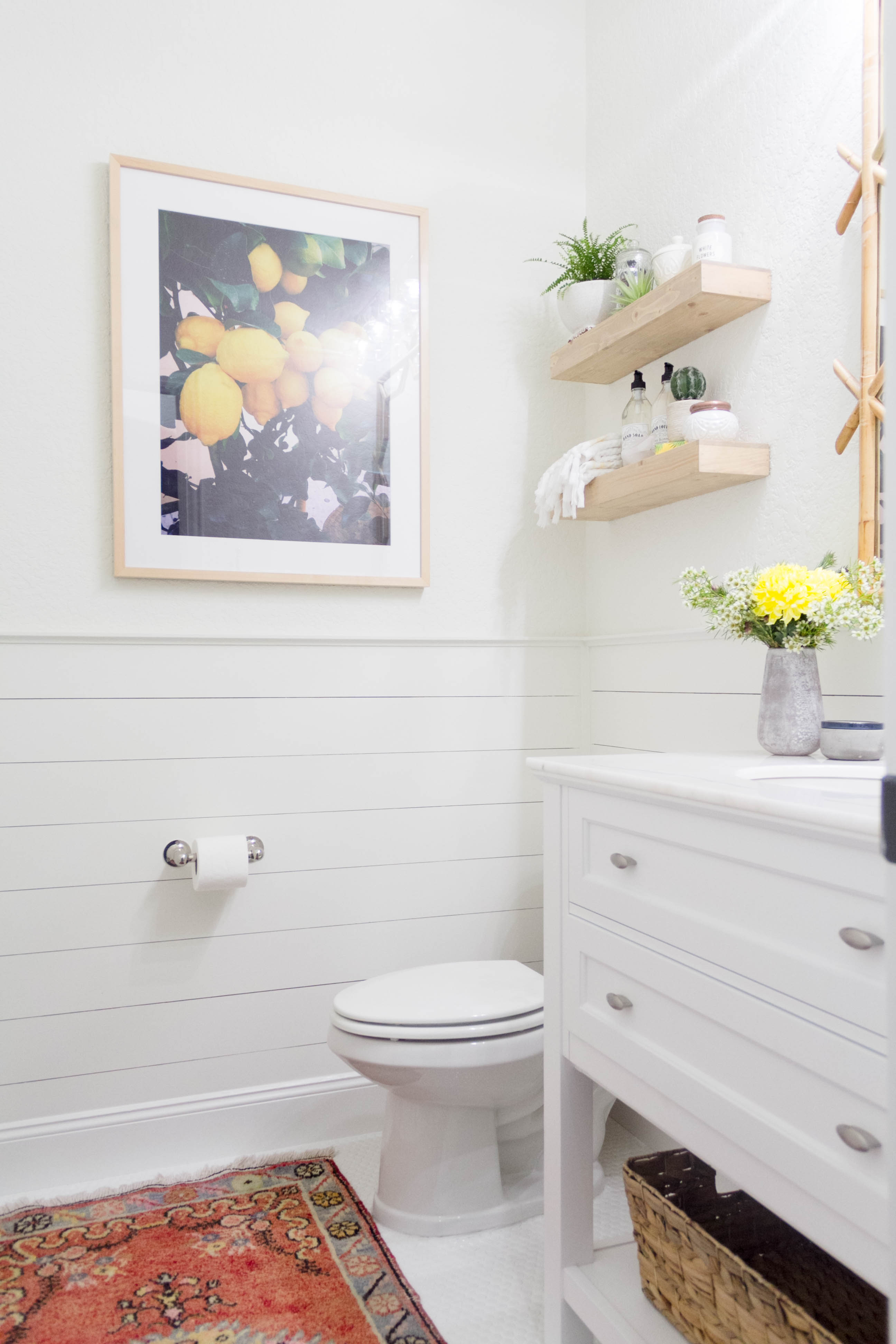 A bright and welcoming mudroom/powder room combo with a modern-casual-beach feel. Designed by: IrisNacole.com