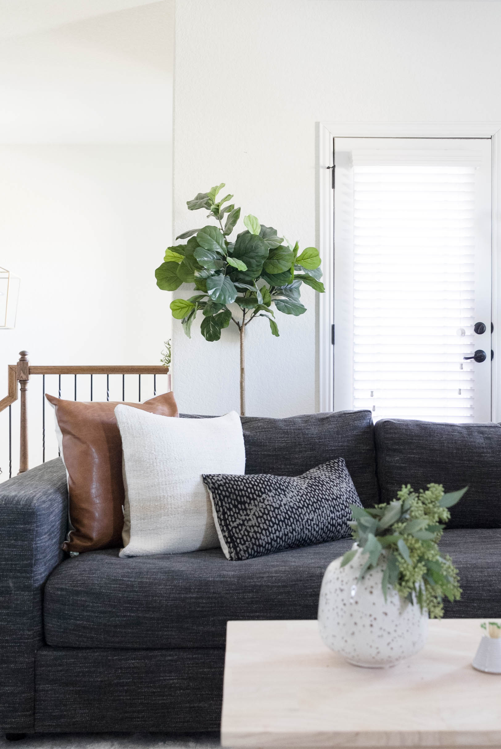 Multi-functional bonus room design by Iris Nacole-Family Friendly Sectional. Fiddle leaf fig Tree, Vintage pillows