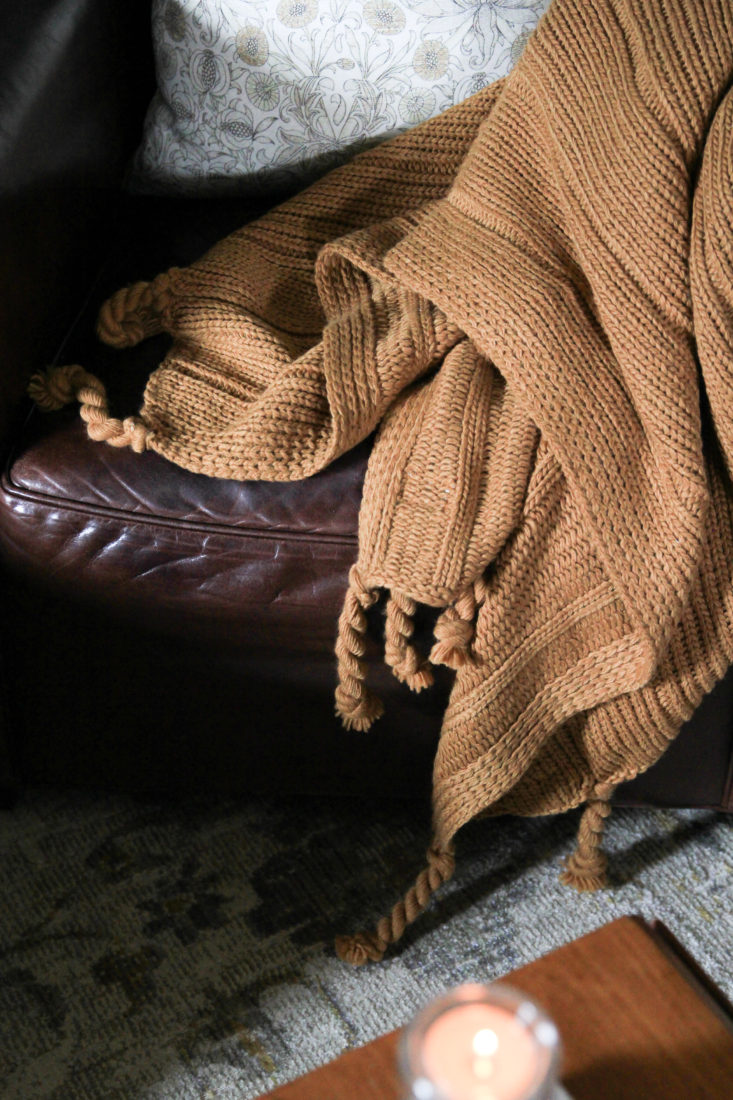 Chunky Knit Throw styled on leather chair for fall decor.