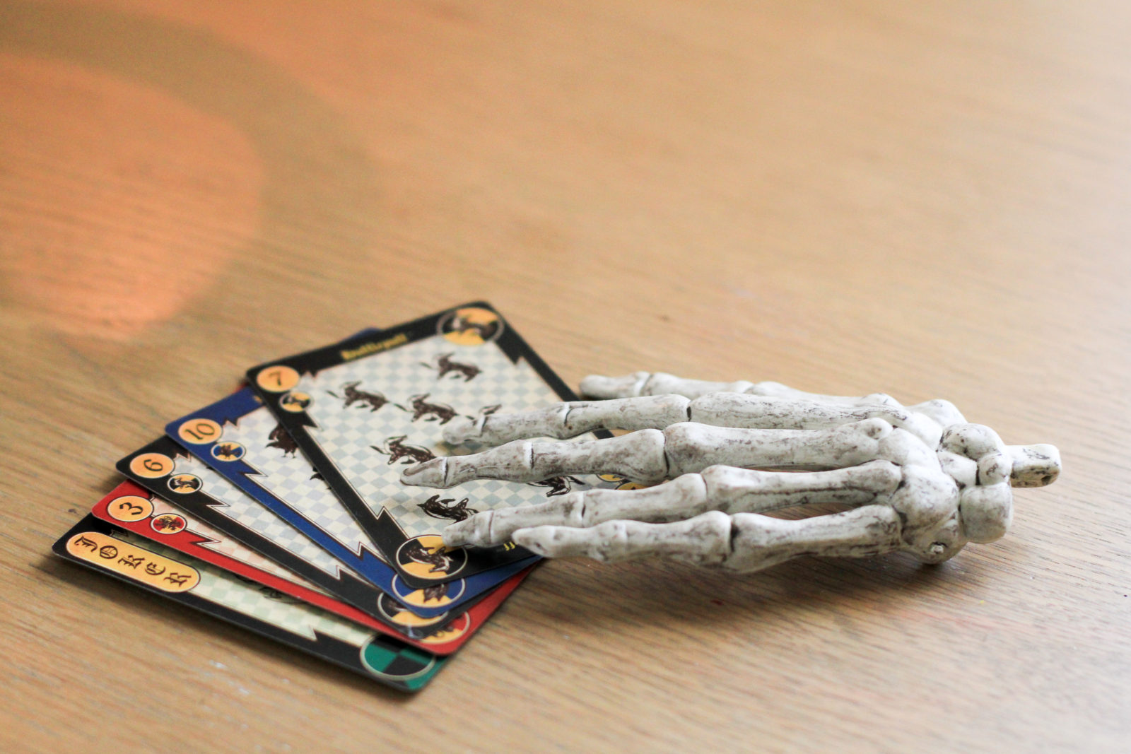 Faux skeleton hand and spider playing cards
