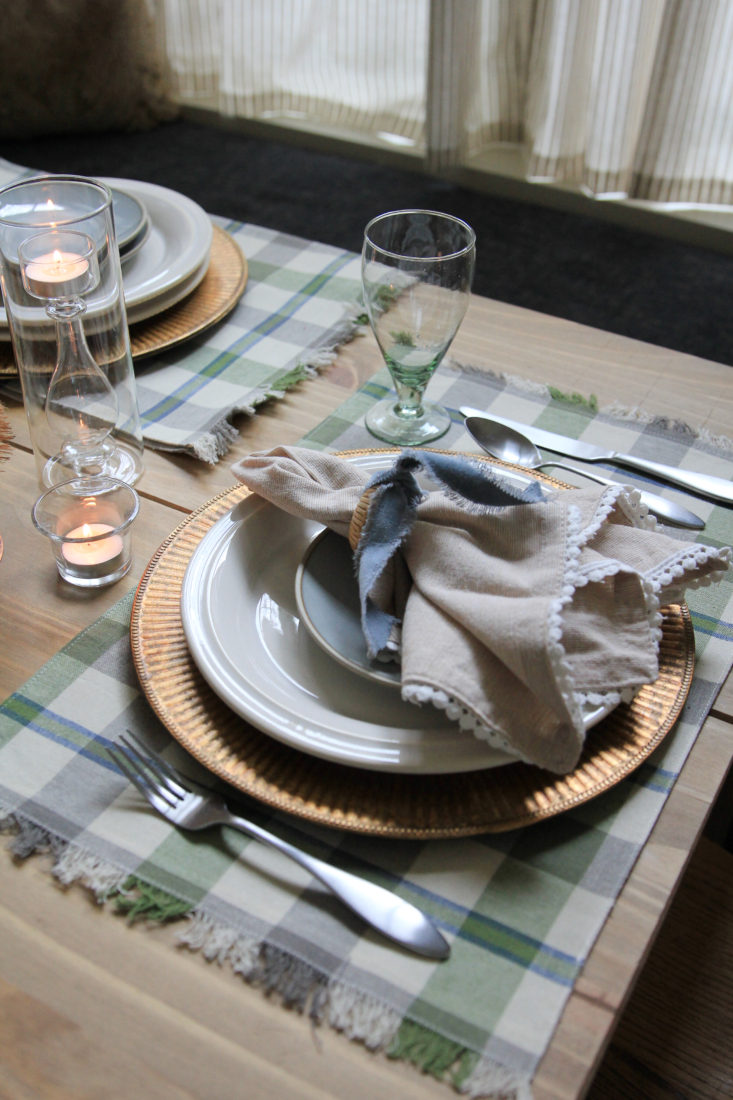 Holiday place setting, plaid placemats, copper  Charger Plates, with ceramic dinner plates and Linen Napkins