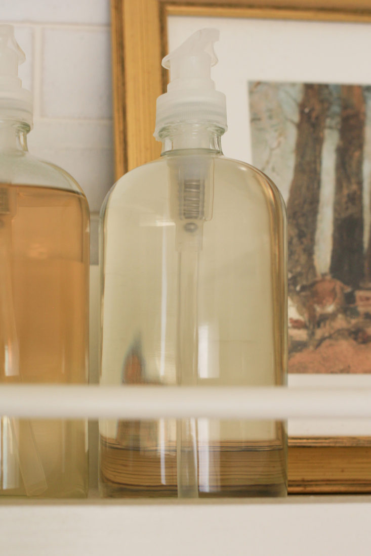 Glass bottles as storage in laundry room.
