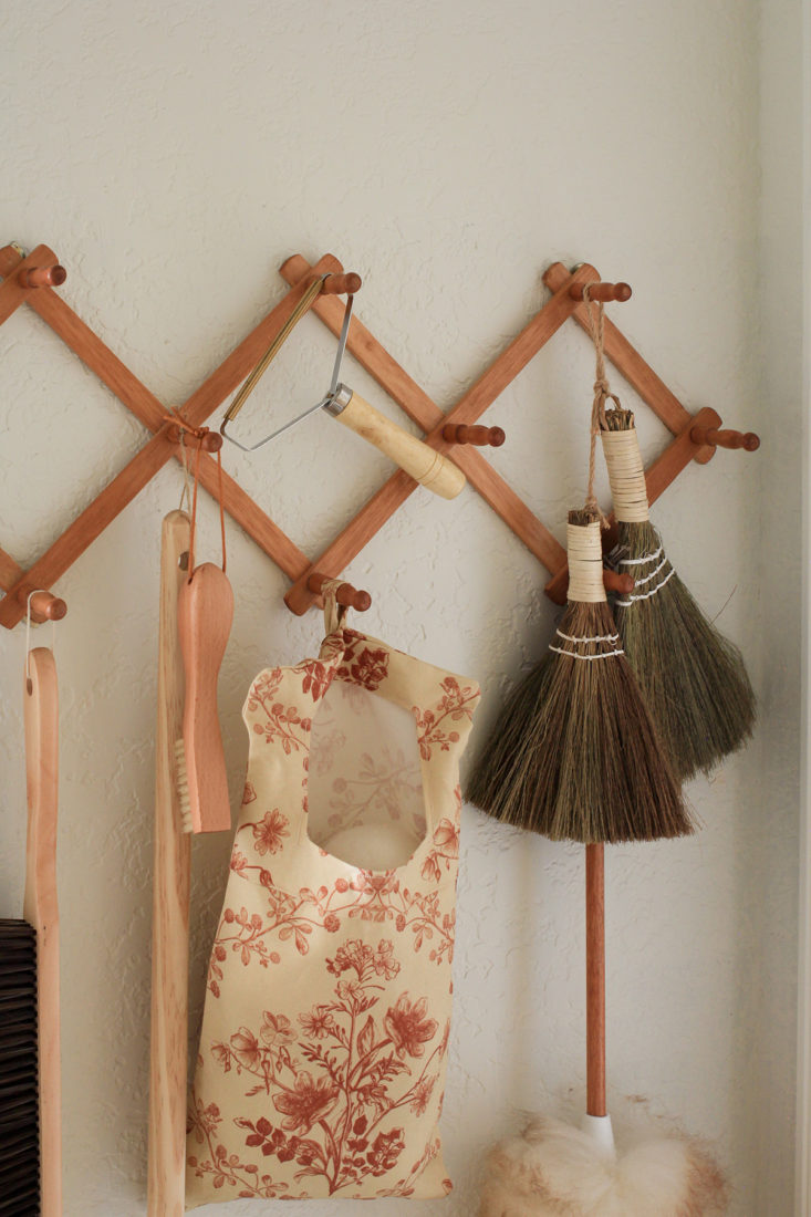 Accordion peg rack, holding laundry room essentials, and homemade wool laundry ball pouch. 