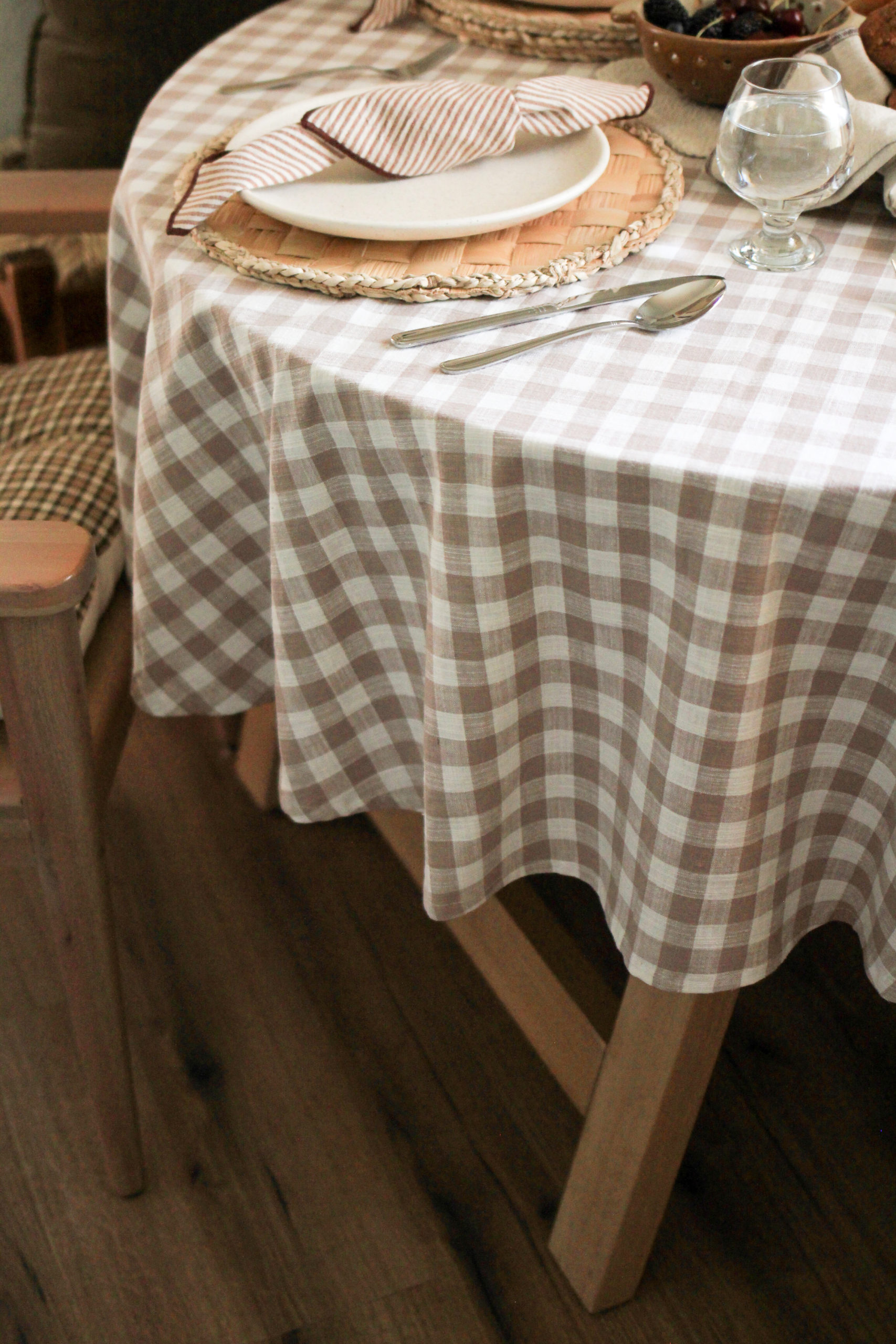 Round table, featuring gingham tablecloth.